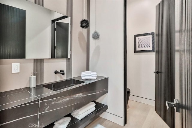 bathroom featuring sink and hardwood / wood-style floors