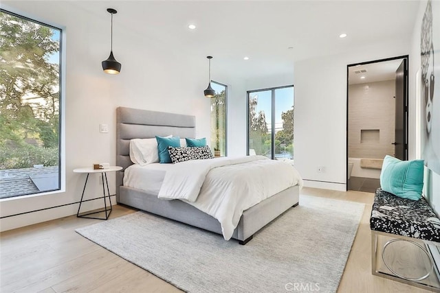 bedroom featuring hardwood / wood-style floors and ensuite bathroom