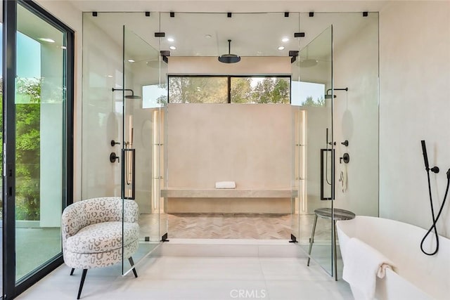 bathroom featuring a towering ceiling and separate shower and tub