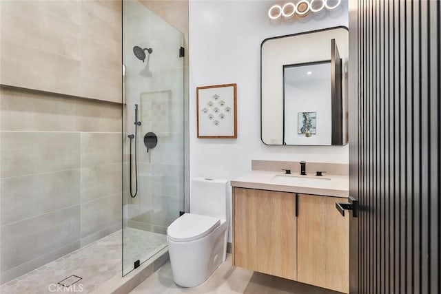 bathroom featuring tiled shower, vanity, and toilet