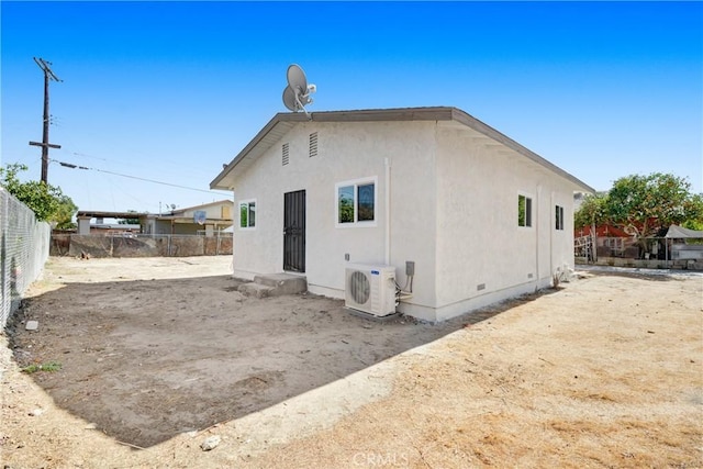 rear view of house featuring ac unit