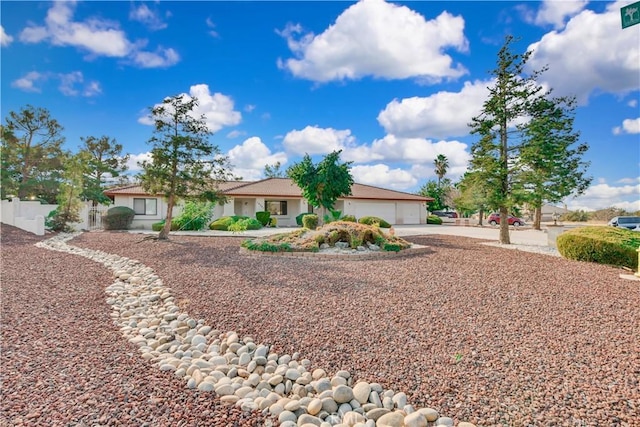 ranch-style home featuring a garage and driveway