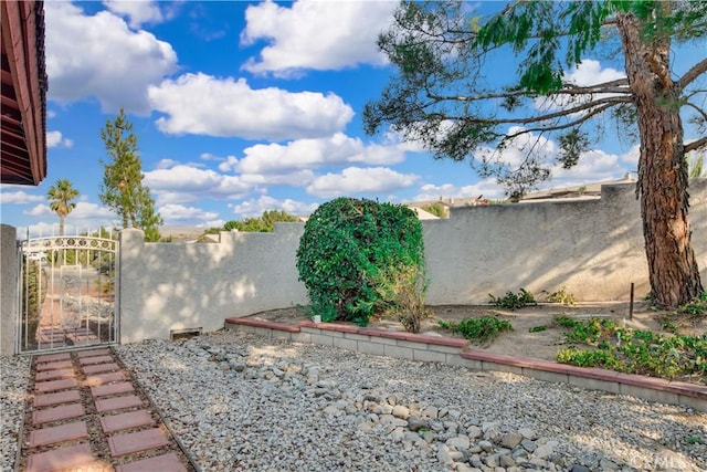 view of yard featuring fence private yard and a gate