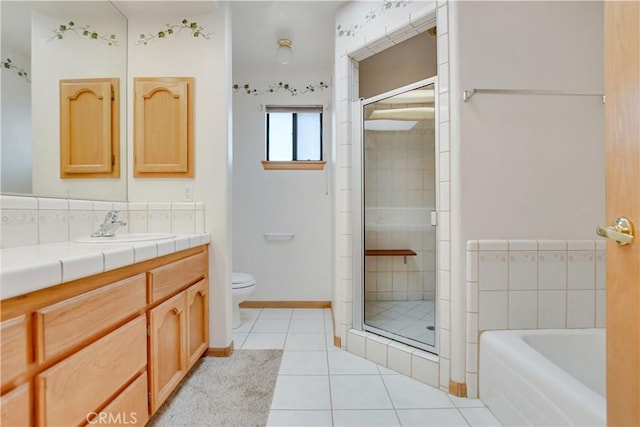 bathroom featuring a stall shower, toilet, tile patterned flooring, vanity, and a bath