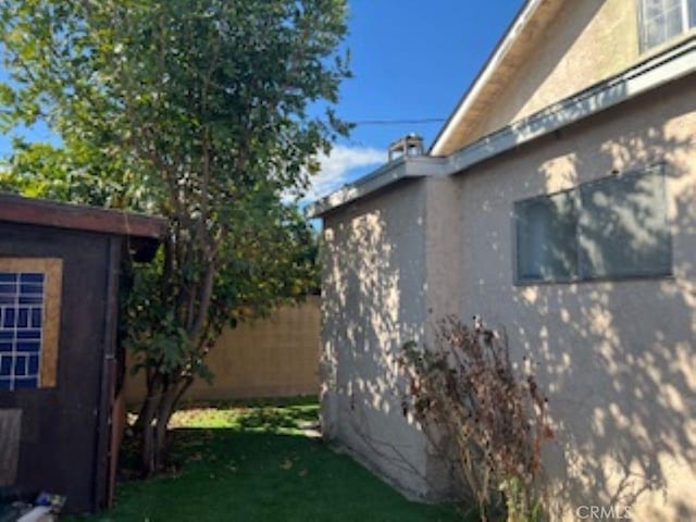 view of home's exterior featuring fence and stucco siding