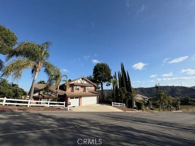 view of front facade featuring a mountain view and a garage