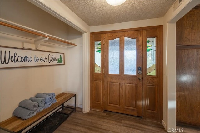 foyer featuring dark wood-type flooring and a textured ceiling