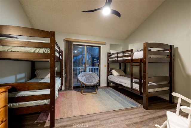 bedroom with vaulted ceiling, access to outside, hardwood / wood-style floors, and ceiling fan