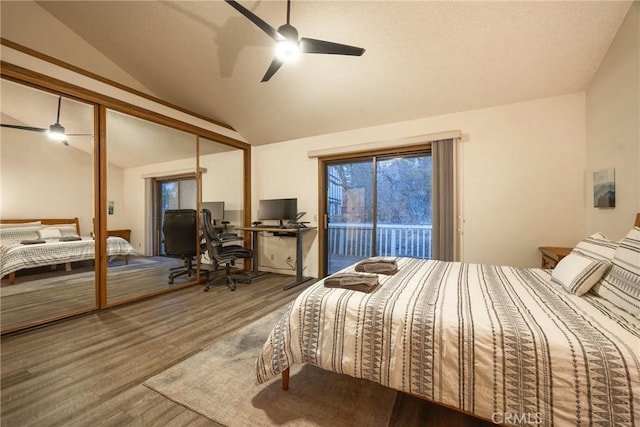 bedroom with wood-type flooring, lofted ceiling, access to exterior, ceiling fan, and a closet