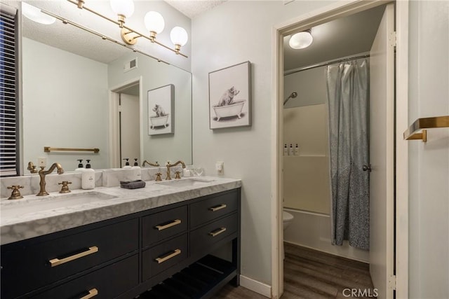 full bathroom featuring vanity, hardwood / wood-style flooring, toilet, and shower / tub combo with curtain