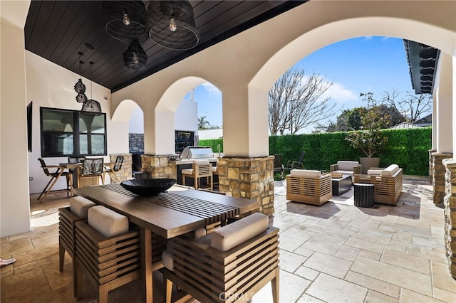 view of patio / terrace featuring an outdoor kitchen, ceiling fan, and an outdoor hangout area