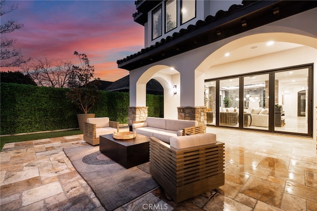 patio terrace at dusk with an outdoor living space