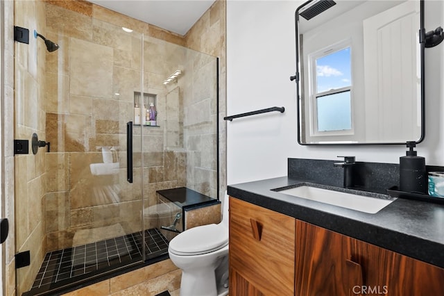 bathroom with vanity, walk in shower, and toilet