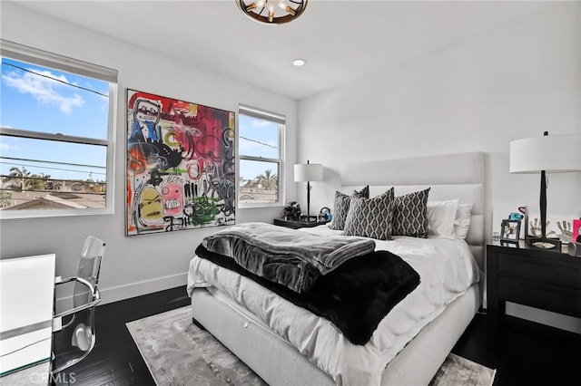 bedroom with dark hardwood / wood-style floors