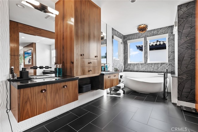 bathroom featuring vanity, tile walls, and a tub