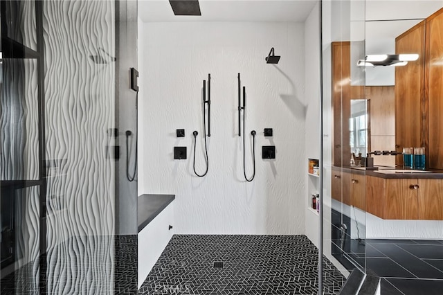 bathroom featuring vanity, tile patterned floors, and a shower