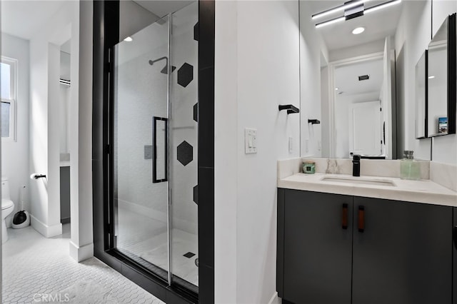 bathroom with vanity, an enclosed shower, and toilet