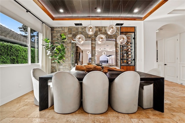 dining room with wooden ceiling and a raised ceiling