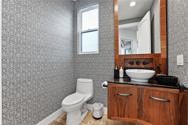 bathroom with vanity, tile patterned flooring, and toilet