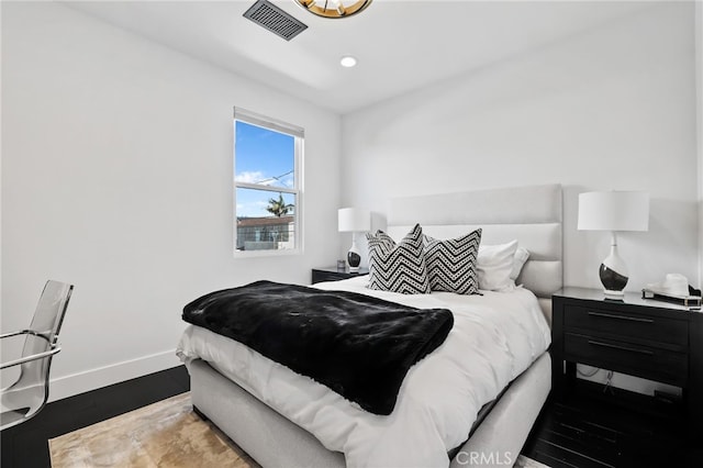 bedroom with wood-type flooring