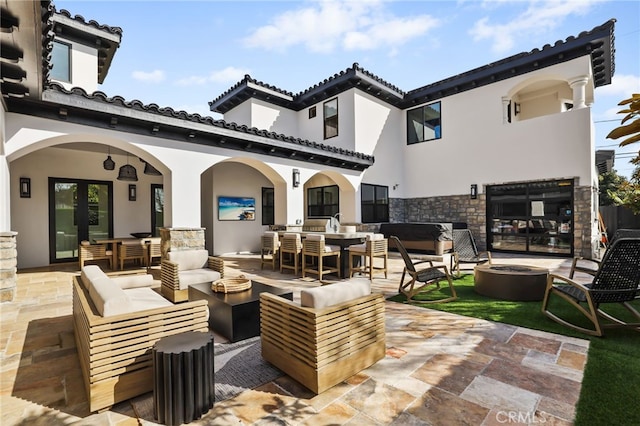 view of patio / terrace featuring an outdoor living space with a fire pit