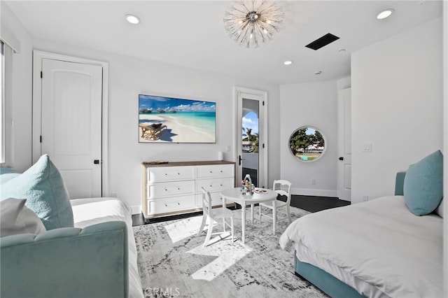 bedroom with wood-type flooring and a chandelier