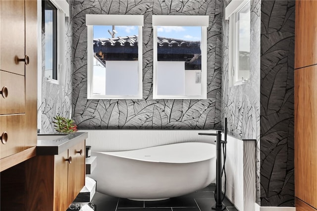 bathroom with vanity and a tub