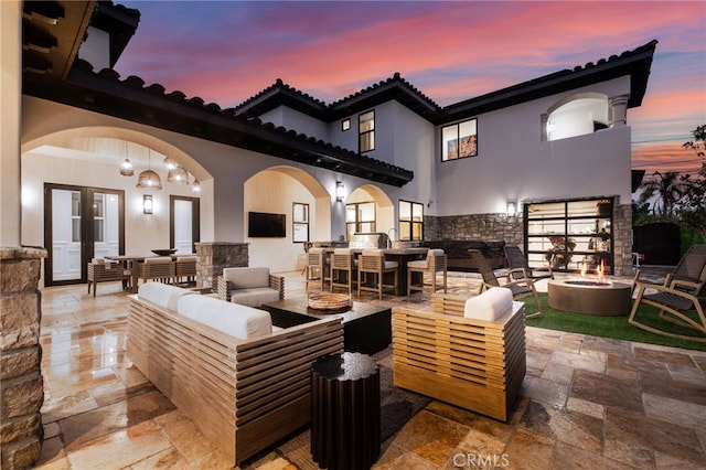 view of patio featuring an outdoor living space with a fire pit