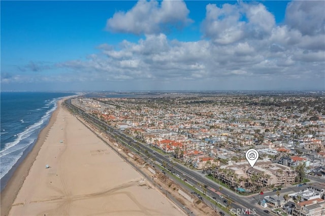 birds eye view of property with a water view and a view of the beach