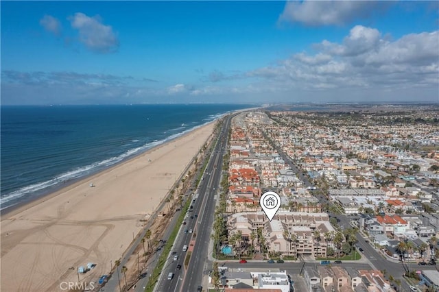 drone / aerial view featuring a beach view and a water view