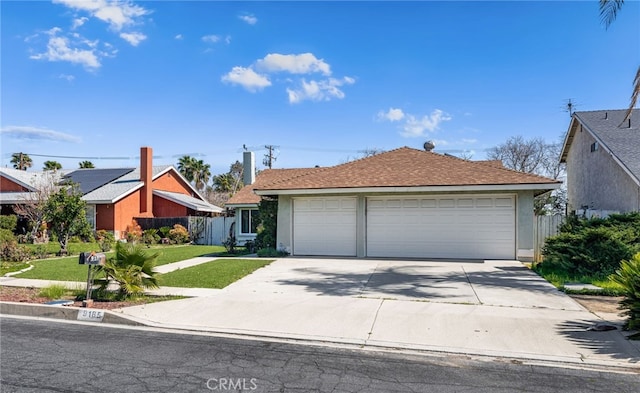 view of front of house with fence, a front lawn, and stucco siding