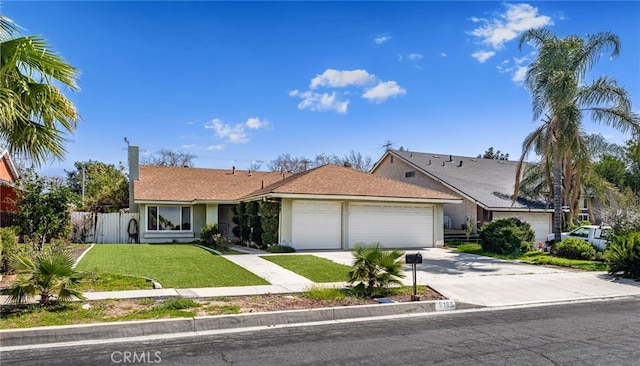 single story home featuring concrete driveway, an attached garage, fence, a front yard, and stucco siding