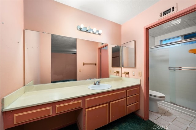 bathroom with visible vents, toilet, a shower stall, vanity, and tile patterned flooring