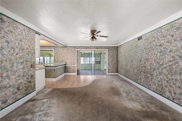 spare room with wallpapered walls, ornamental molding, and a textured ceiling