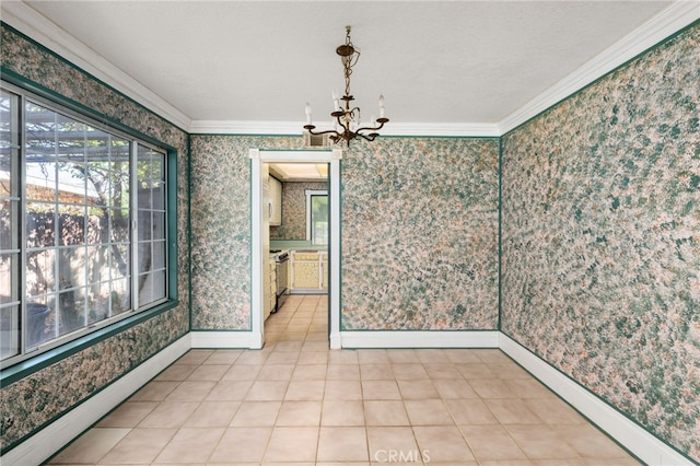 empty room with ornamental molding, a notable chandelier, and wallpapered walls