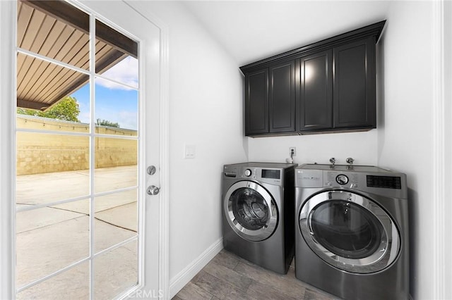 washroom with cabinets and washer and dryer