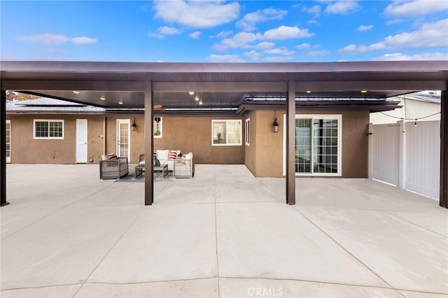 patio terrace at dusk featuring an outdoor hangout area