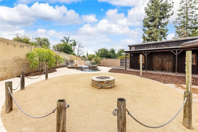 view of yard featuring an outdoor fire pit and a patio