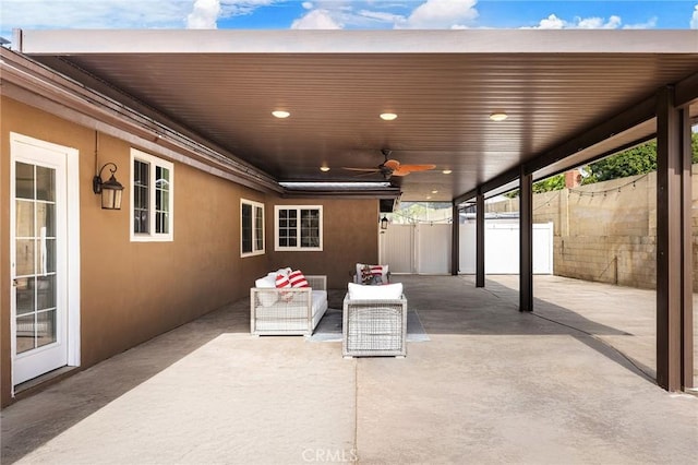 view of patio with an outdoor living space and ceiling fan