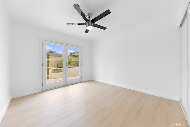 spare room with french doors, ceiling fan, and light wood-type flooring