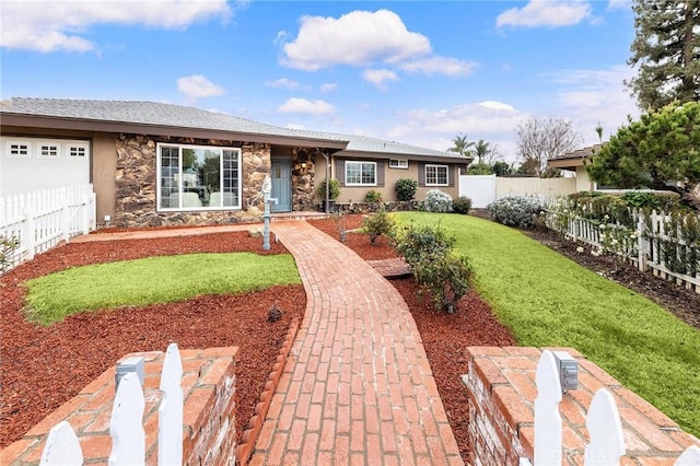 ranch-style house featuring a garage and a front lawn