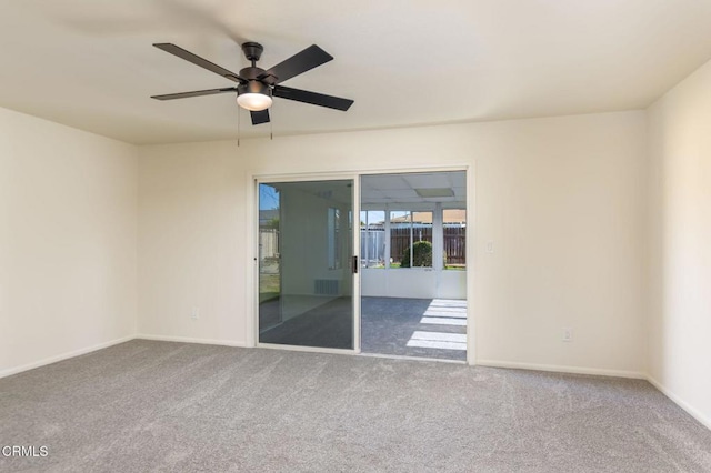 spare room with carpet flooring and ceiling fan