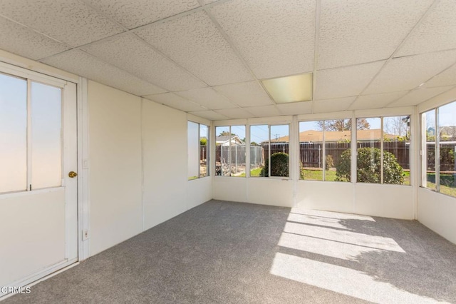 unfurnished sunroom featuring a drop ceiling