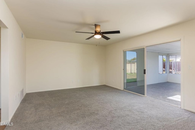 carpeted spare room featuring ceiling fan