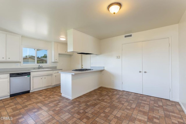 kitchen featuring white cabinetry, stainless steel appliances, kitchen peninsula, and sink