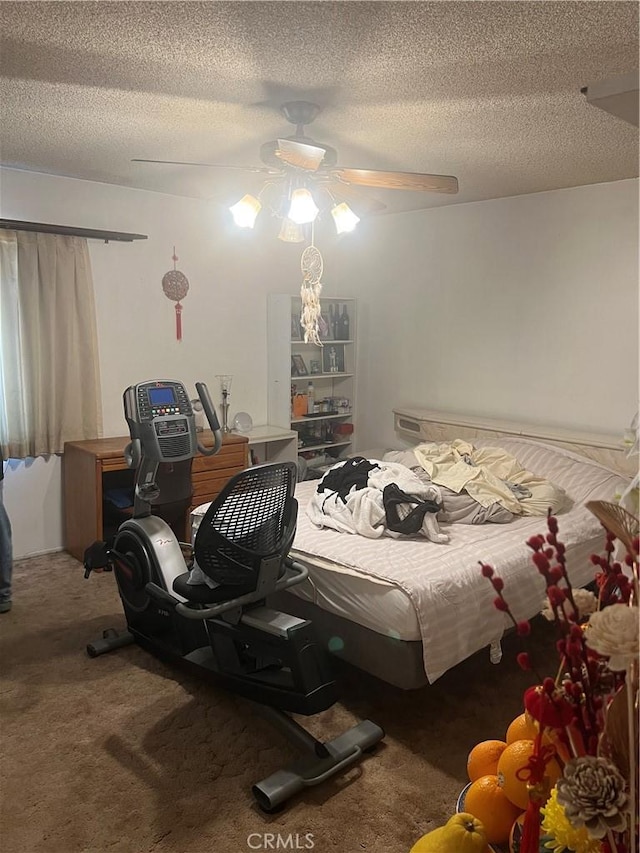 bedroom featuring ceiling fan, carpet flooring, and a textured ceiling