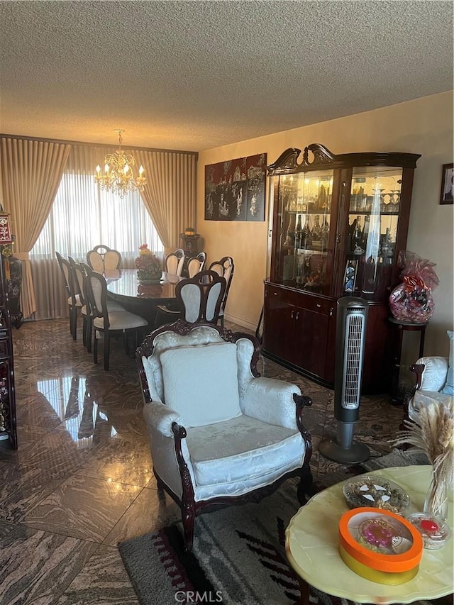 living room with a notable chandelier and a textured ceiling