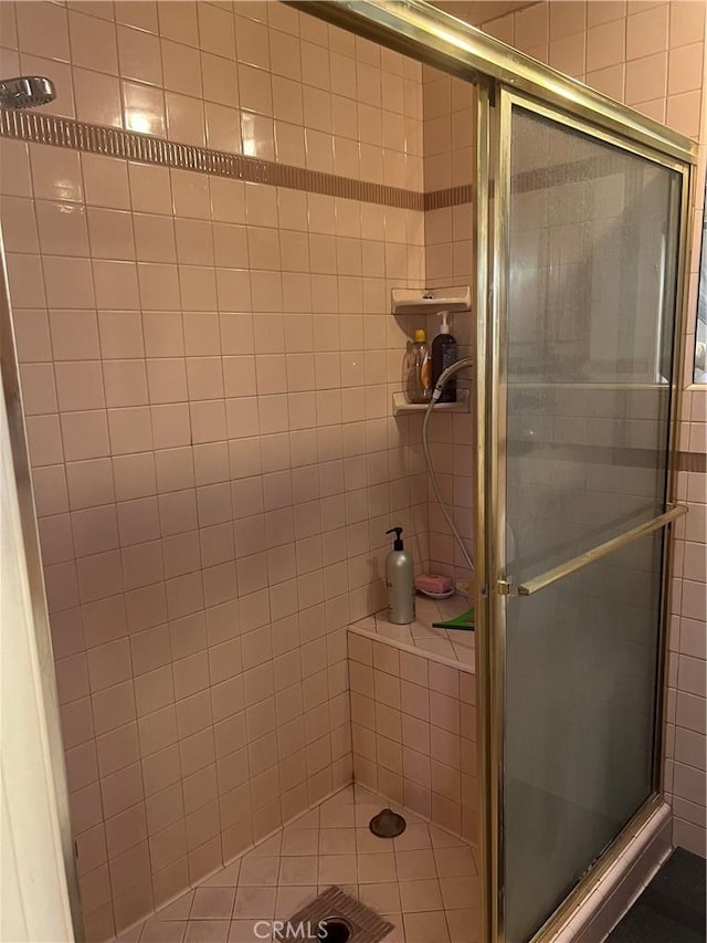 bathroom featuring a shower with door