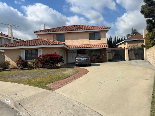 mediterranean / spanish-style home with a garage and a front yard