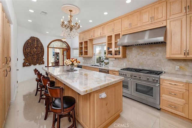 kitchen with range with two ovens, pendant lighting, glass insert cabinets, a kitchen island, and extractor fan